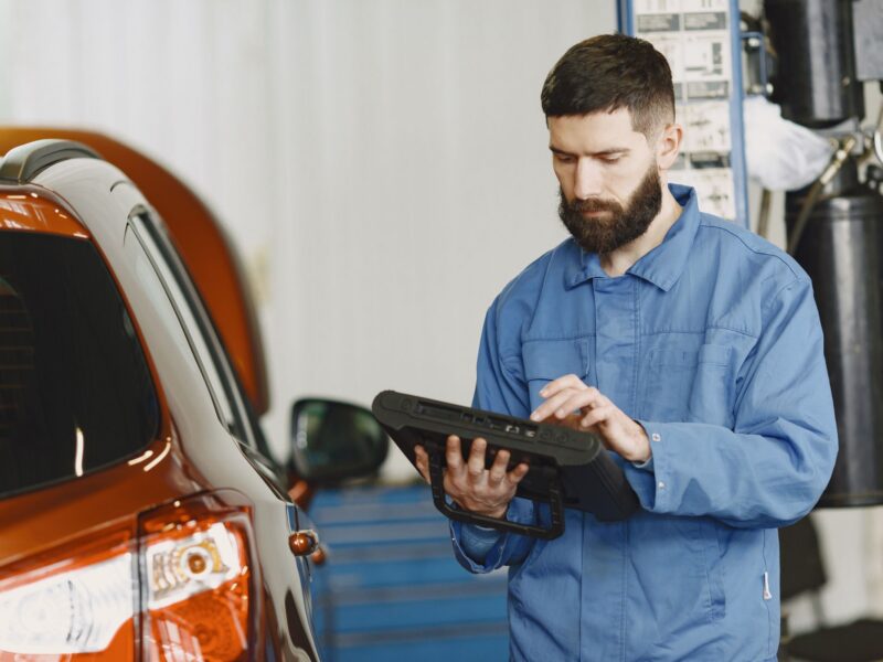 Mechanic checking a car with a diagnostic tablet